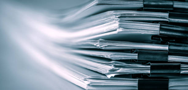 istock extreamely close up  report paper stacking of office working document , retro color tone 968272428