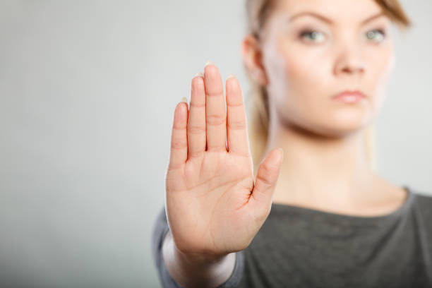 istock Female shows stop sign by her hand. 968275032