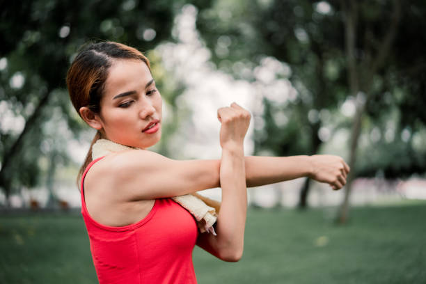 istock portrait strength woman stretching bicep muscle. 968278992