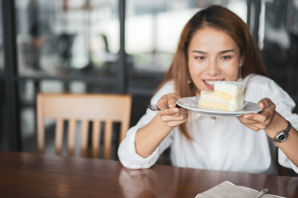 istock Woman eating cake at dessert cafe. 968292392