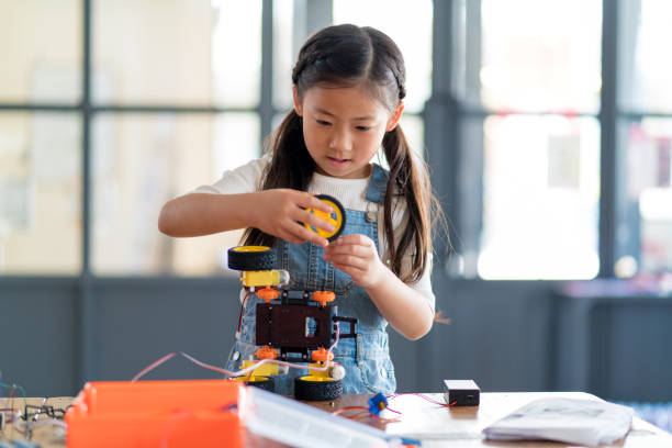 istock Young girl working on a robot design 968296160