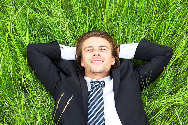 istock Well-dressed young businessman is resting in a field 96829840