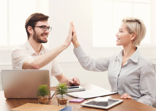 istock Young happy business partners in office with computer 968299876