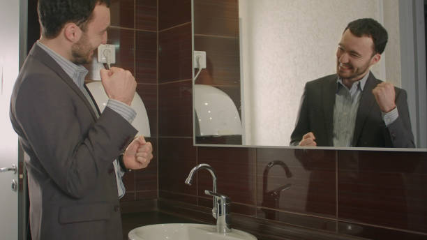istock Businessman takes a look at himself in the mirror 968300404