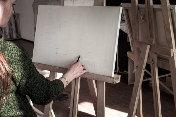 istock Artistic equipment. Empty artist canvas on easel. Retro toned photo. 968306208