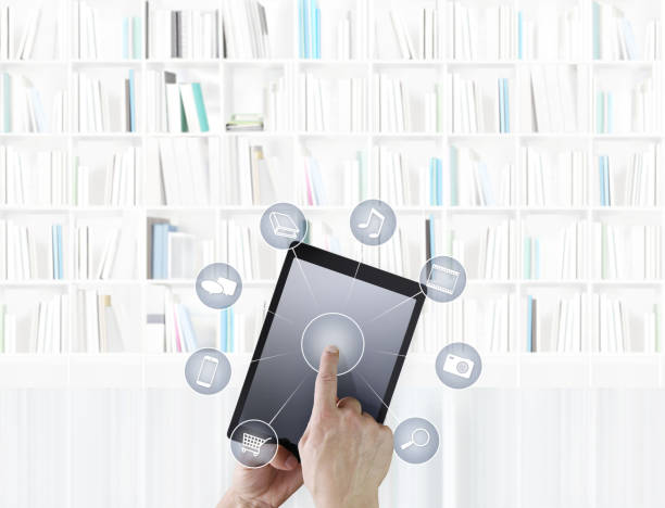 istock hand touching digital tablet with icons isolated on library background 968306888