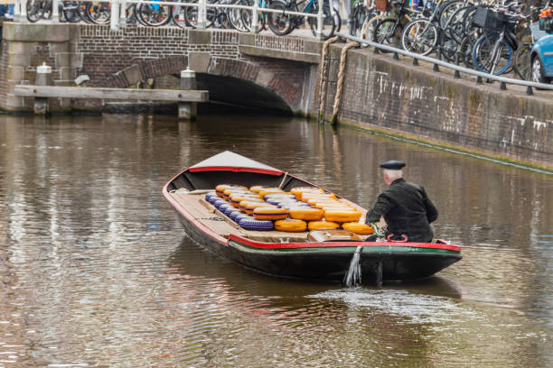 Large boat for transporting alkmaar cheeses. netherlands holland Great transport boat full of exquisite Dutch cheeses about to cross one of the many drawbridges. alkmaar netherlands holland cheese market stock pictures, royalty-free photos & images