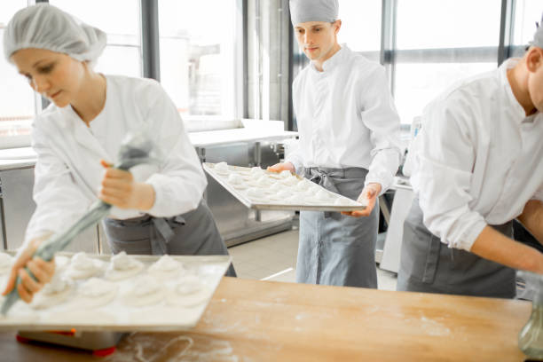 istock Bakers making buns at the manufacturing 968322130