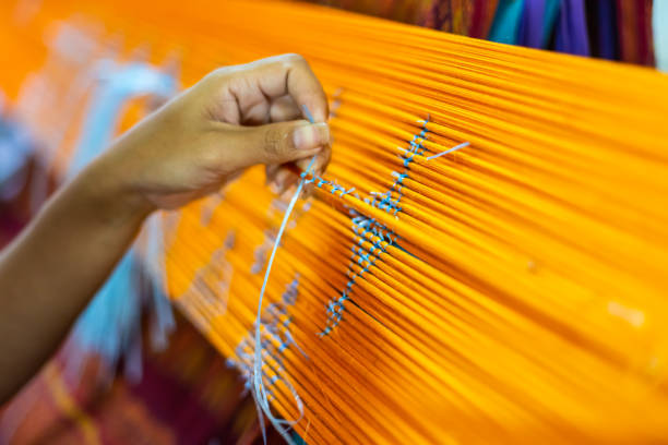 istock Asia Woman Procedure Making Thai Silk Pattern weaving in small weaving mill 968324802
