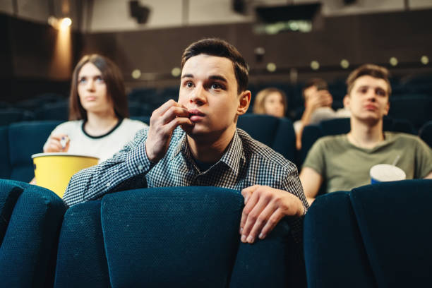 istock Scared man watching movie in cinema 968325648