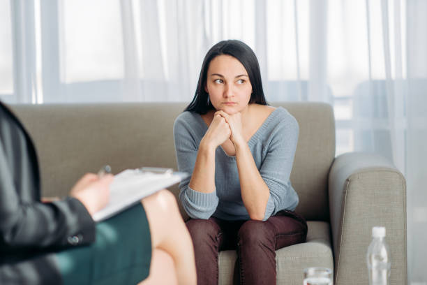 istock Patient sitting on sofa, psychotherapist reception 968331666
