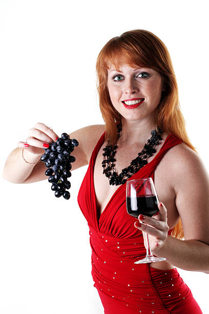 beautiful girl holds a grapes and red wine glass stock photo