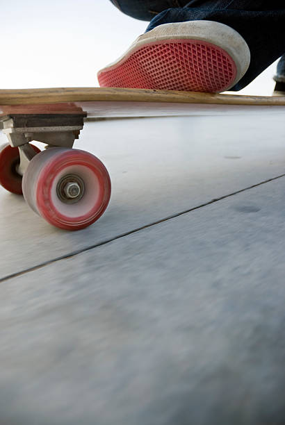 スケートボードアクション - kneeling skateboarding skateboard vertical ストックフォトと画像