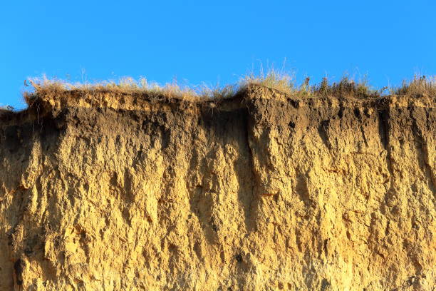 istock Red loamy rock (cliff of the orange clay) and sandy sea beach 968360134