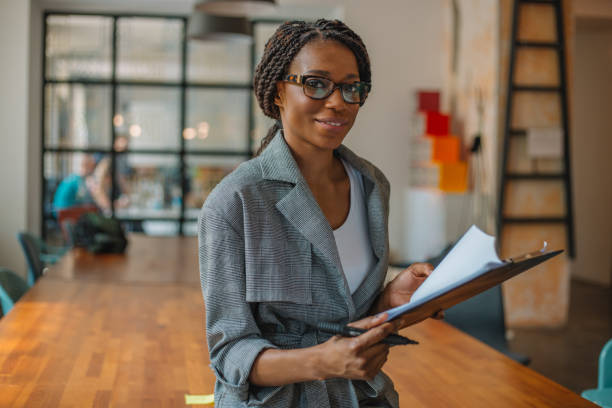 istock Portrait of smiling woman while working in office 968372162