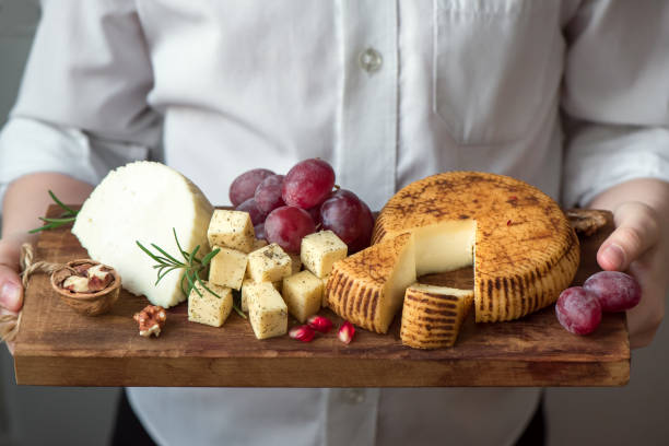 istock cheese platter in hands of cheese maker 968372366
