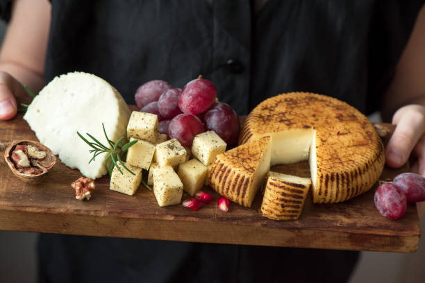 istock cheese platter in hands of cheese maker 968372368