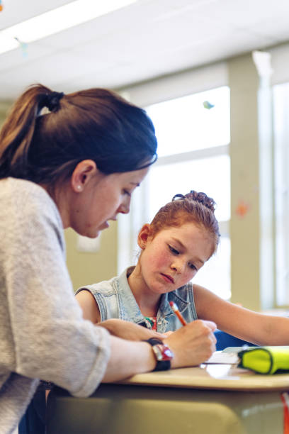 istock Teacher helping student for an academic catch up 968372510