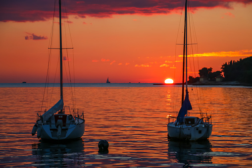 The sun is on the horizon and Rovinj is in the background