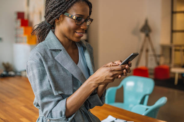 istock Young businesswomen texting on smartphone in the office 968373134