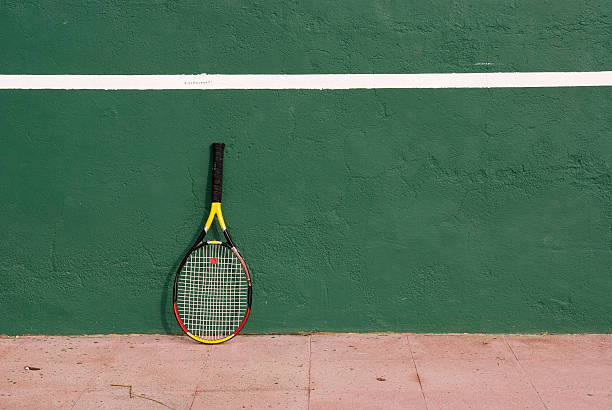 istock racket resting on the tennis wall 96837539