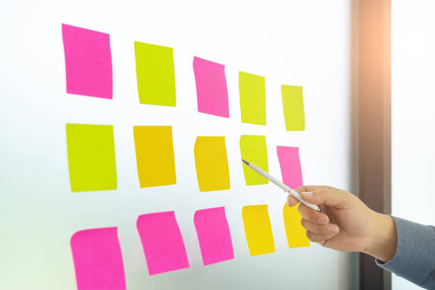 istock Businessman hands are pointing to empty sticky notes on glass wall at Meeting Conference Discussion Corporate. 968376654