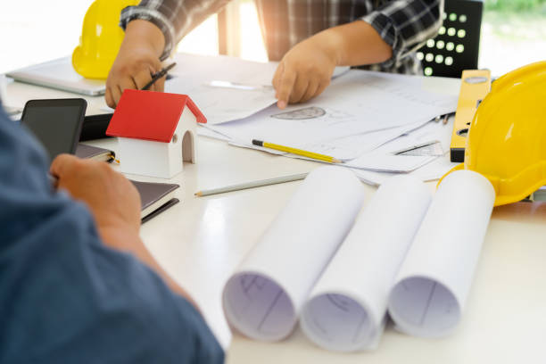 istock Male Architects designing,sketching the building construction project. 968377304