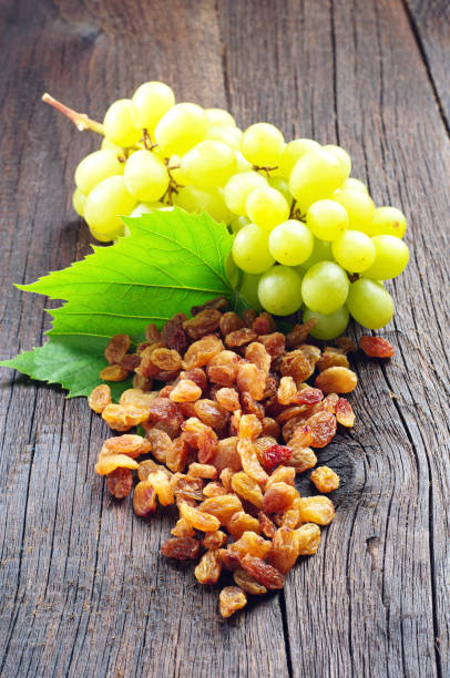 istock Raisins and grapes with leaves 968383502