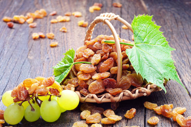 istock Raisin in a wicker basket and grapes 968383618