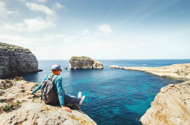 istock Coastal walker relax on rocky seaside 968384200
