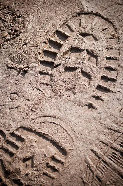 Photo of A boot print in the mud close-up