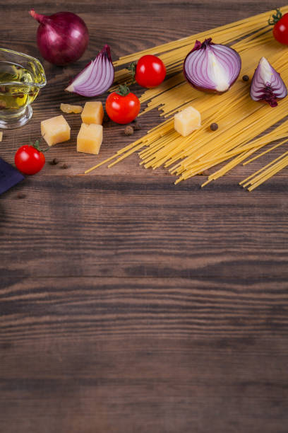 istock Ingredients for cooking spaghetti - raw pasta, tomato, olive oil, spices, herbs 968416404