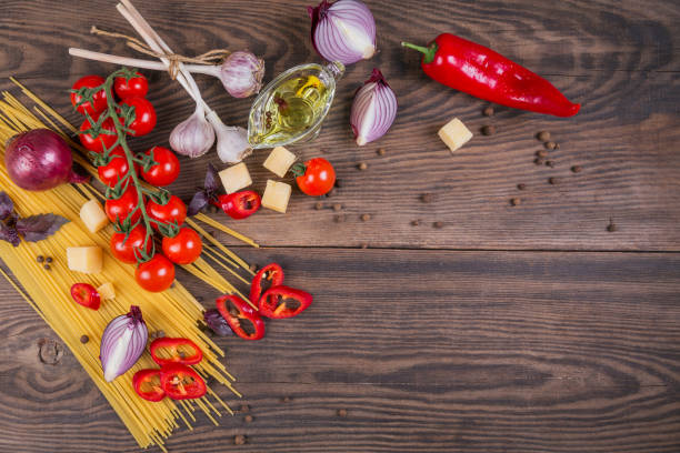 istock Ingredients for cooking spaghetti - raw pasta, tomato, olive oil, spices, herbs 968416416