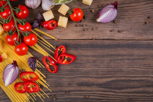 istock Ingredients for cooking spaghetti - raw pasta, tomato, olive oil, spices, herbs 968416428