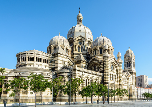 Three-quarters rear view of the cathedral of Marseille, Sainte-Marie-Majeure also known as La Major, a neo-byzantine style catholic building achieved in 1893, showing cupolas, chapels and turrets.