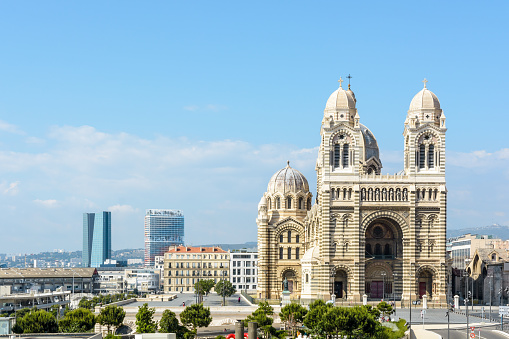 Marseille, France - May 17, 2018: Sainte-Marie-Majeure cathedral, also known as La Major, in La Joliette district with the CMA-CGM tower (left) and 