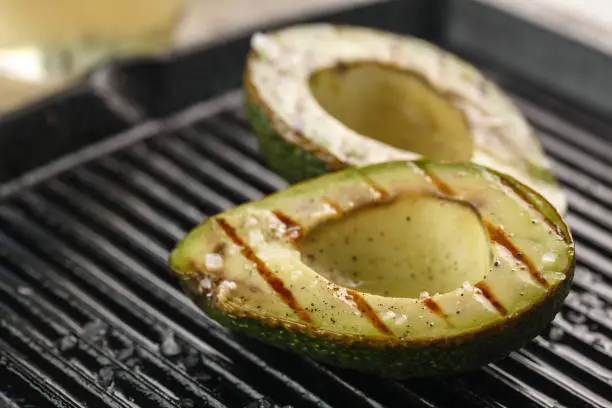 Photo of sliced fresh avocado on the grill. Health food. Barbeque avocado