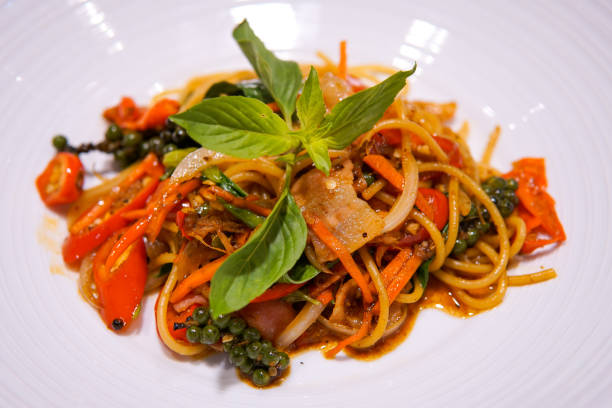 istock Spaghetti spicy ham thai style (PAD KI-MAO) on white dish. 968428582