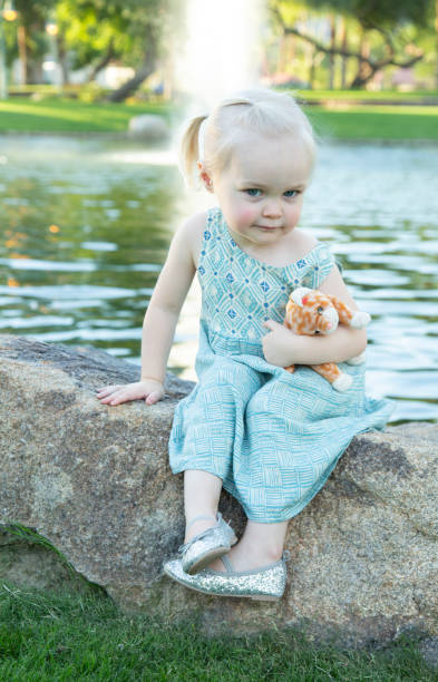 istock Mischievous Little Girl by Pond 968428728