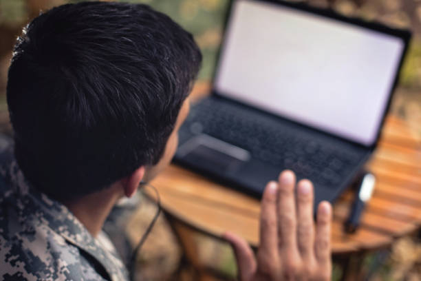 istock Army soldier video chatting with family 968429606