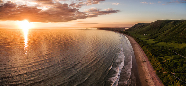 Aerial view of sunset at Rhossili Bay - Rhossili Bay has been voted Wales' Best Beach many times. It is located on the west coast of Gower Peninsular