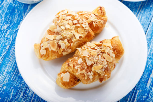 istock fresh bakery. croissants with almond flakes. 968442574