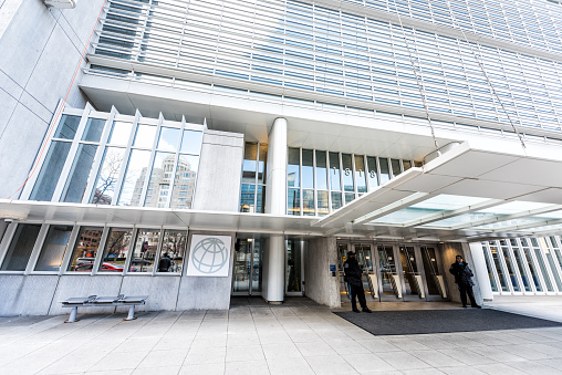 Washington DC, USA - March 9, 2018: World Bank Group entrance, sign and logo with security guards by entrance doors, winter international financial building