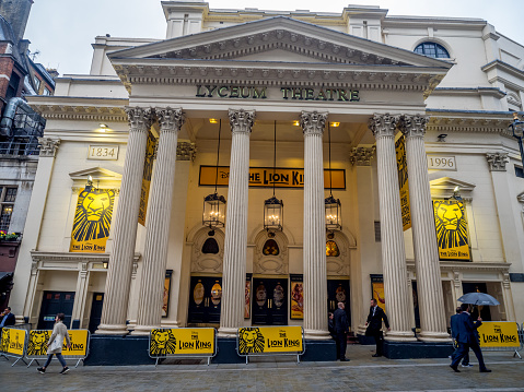 London, England - August 2, 2017: London's Lyceum Theatre on August 2, 2017 in London England. The Lyceum Theatre is a famous London institution and is playing the Lion King. People visible in image.