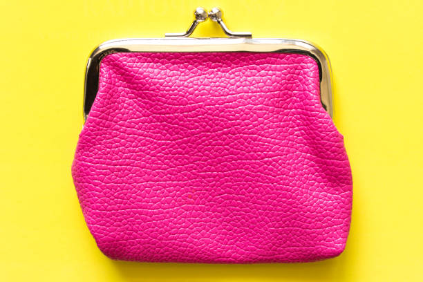 istock Pink wallet on a yellow background . Close up. Top view 968454326