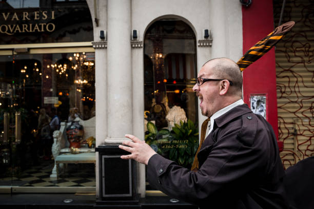 A business man peers inquisitively into the lens.