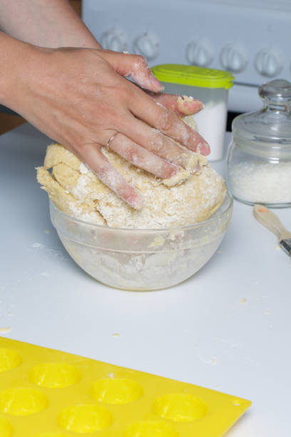 istock The woman kneads the dough in glass container. 968469814