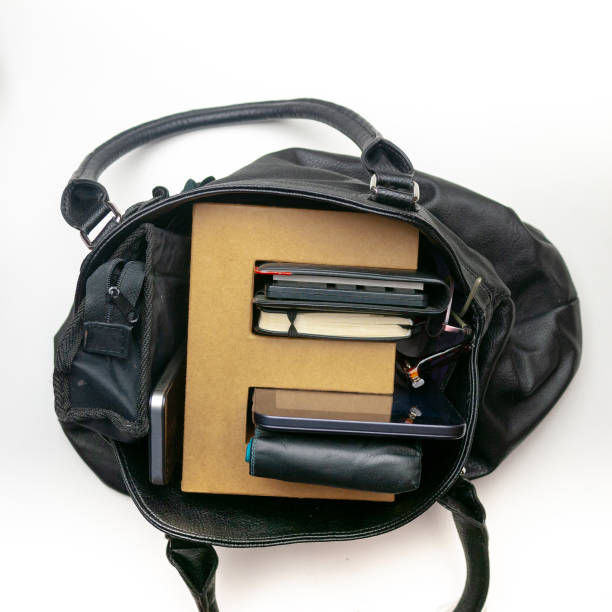 istock Letter E made of brown cardboard just fitting in a black leather purse 968470154