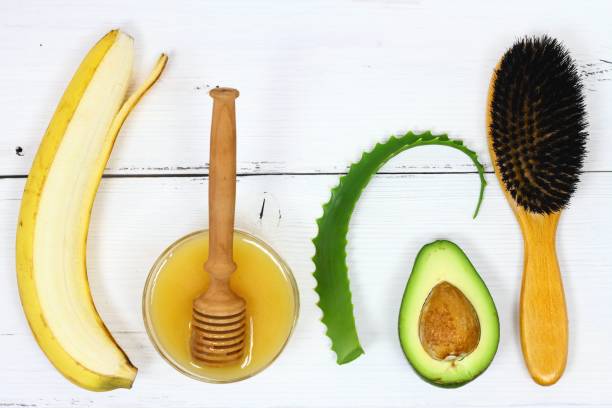 Hair mask fron banana, honey, aloe and avocado Ingredients for hair mask on the white board, top view aloe plant alternative medicine body care stock pictures, royalty-free photos & images
