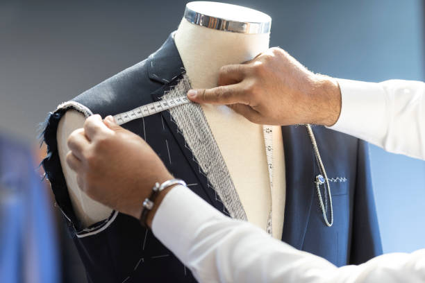 istock Man Measuring Jacket on Male Dress Form 968471028